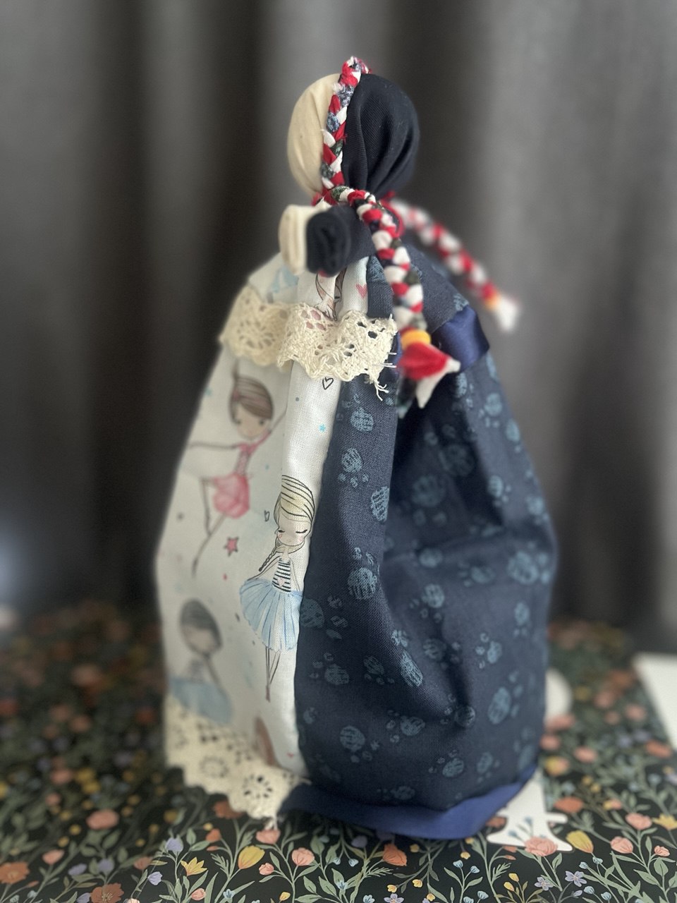 A double-sided handmade doll seen in profile